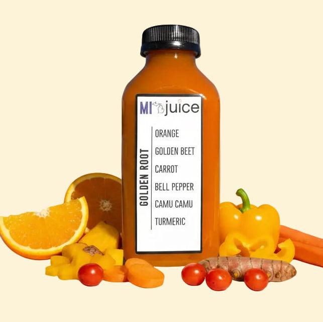 Bottle of juice with ingredients on a beige background