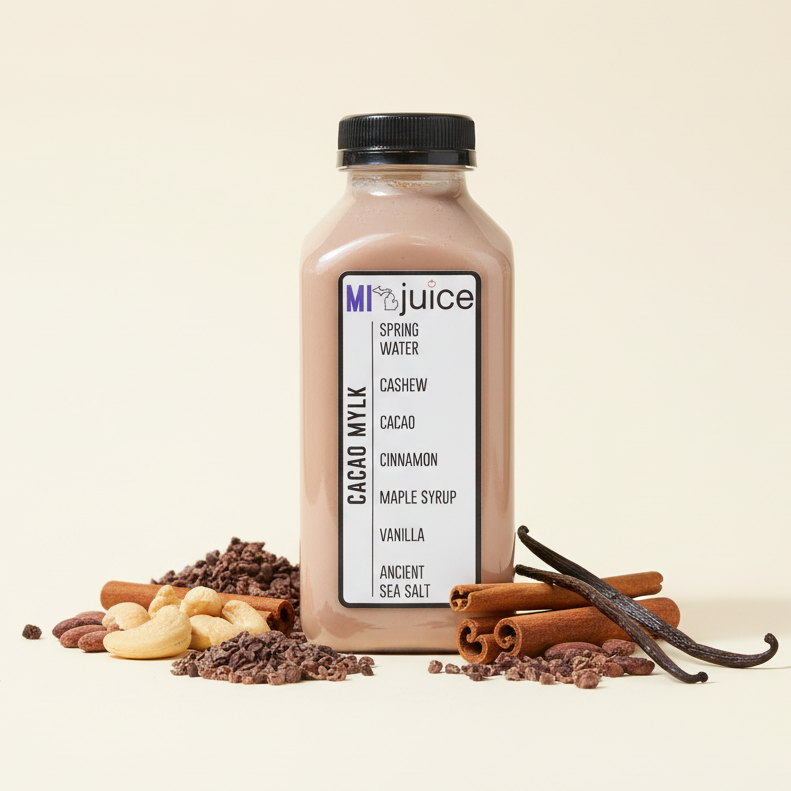 Bottle of MiJuice Cacao Mylk with ingredients on a beige background