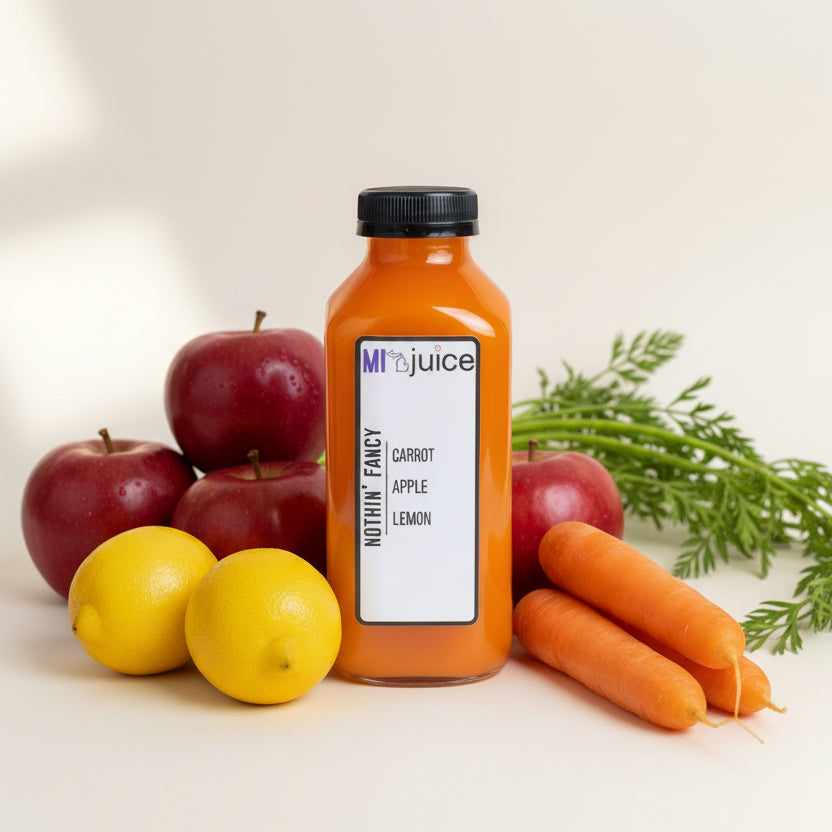 A bottle of juice labeled 'Nothin' Fancy' with ingredients carrot, apple, and lemon written on it, with a white background 