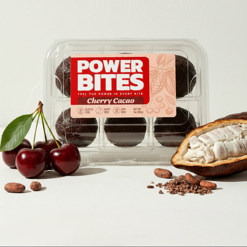 Packaged Power Bites Cherry Cacao snack bars on a neutral background